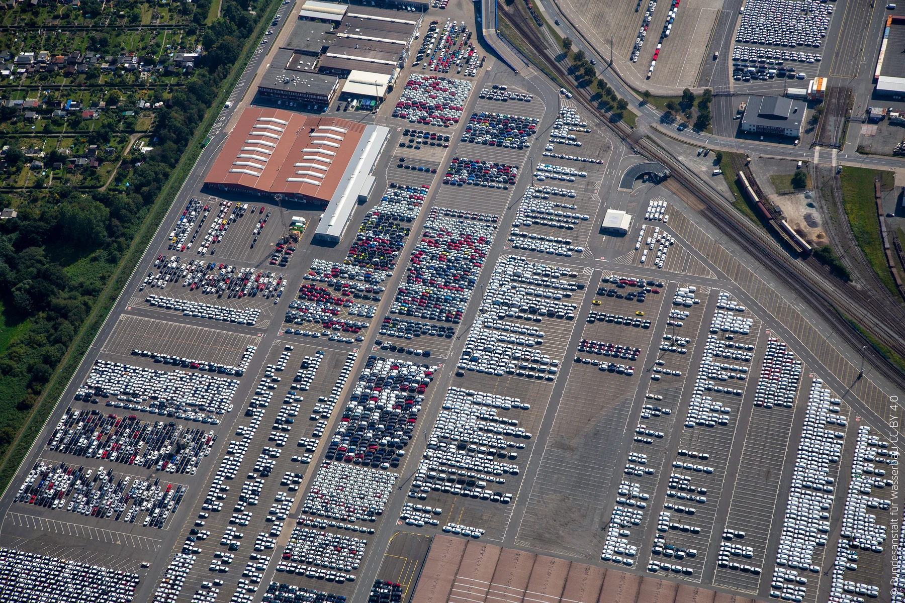 Aerial view of densely arranged cars and railway lines at the Bremerhaven vehicle terminal in Germany